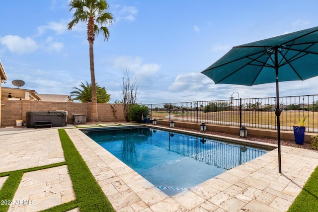 view of pool featuring a hot tub and a patio area