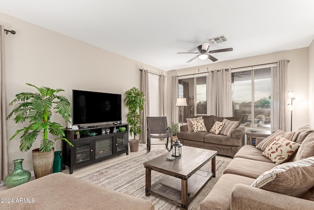 living room featuring ceiling fan and light wood-type flooring