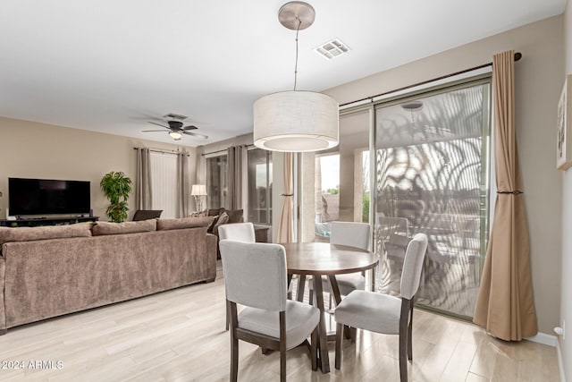 dining space featuring ceiling fan and light hardwood / wood-style flooring