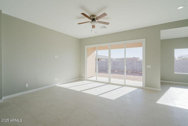 tiled empty room featuring ceiling fan