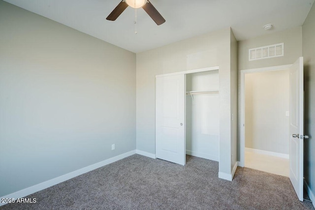 unfurnished bedroom with ceiling fan, a closet, and carpet flooring