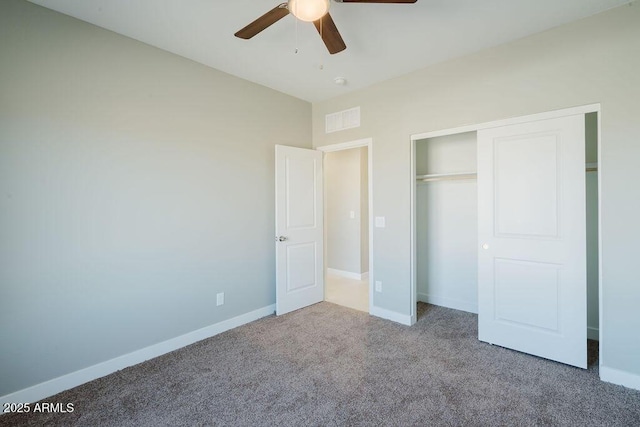 unfurnished bedroom with ceiling fan, a closet, and carpet flooring