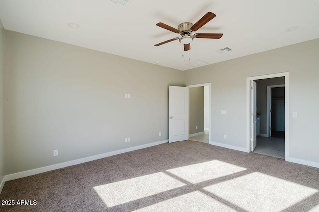 unfurnished bedroom with ceiling fan, a walk in closet, and carpet