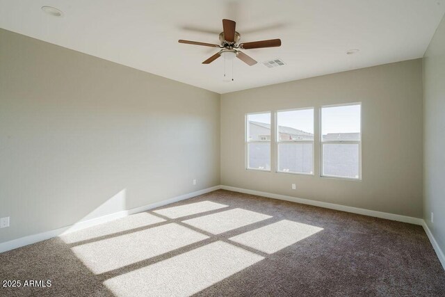 carpeted spare room featuring ceiling fan