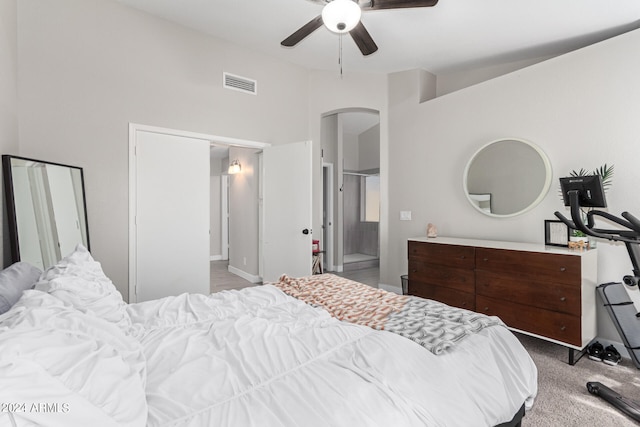 bedroom featuring ensuite bathroom, ceiling fan, and light colored carpet