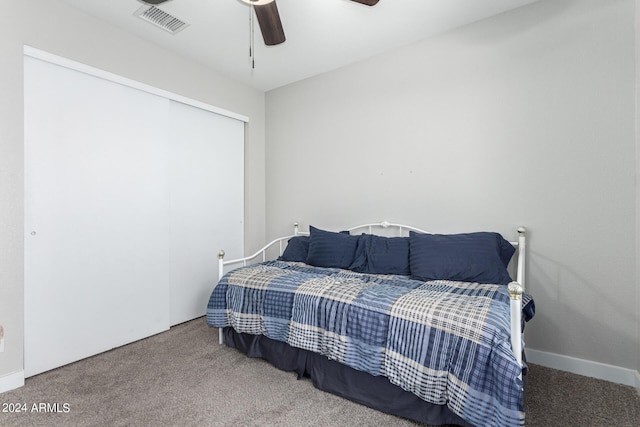 carpeted bedroom with a closet and ceiling fan