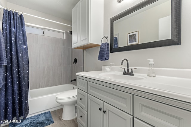 full bathroom with shower / tub combo, vanity, toilet, and wood-type flooring