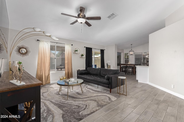 living room with wood-type flooring, lofted ceiling, and ceiling fan