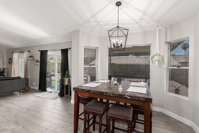 dining room with an inviting chandelier and light hardwood / wood-style floors