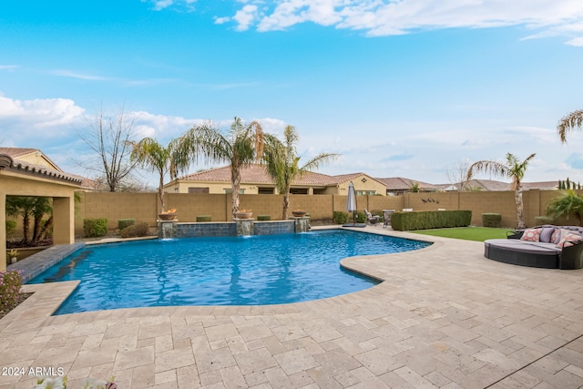 view of pool with a patio area and pool water feature