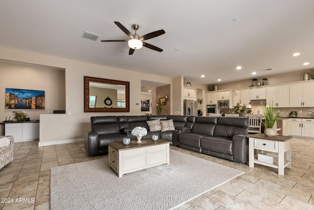 tiled living room with ceiling fan