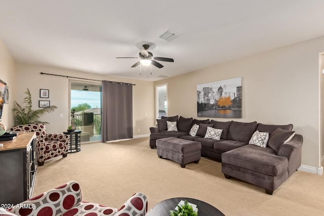 living room with light colored carpet and ceiling fan