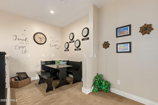 dining space featuring light colored carpet