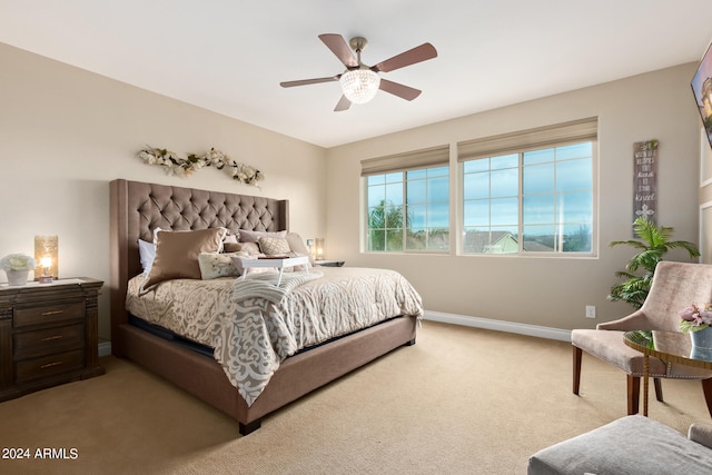 bedroom with ceiling fan and light carpet