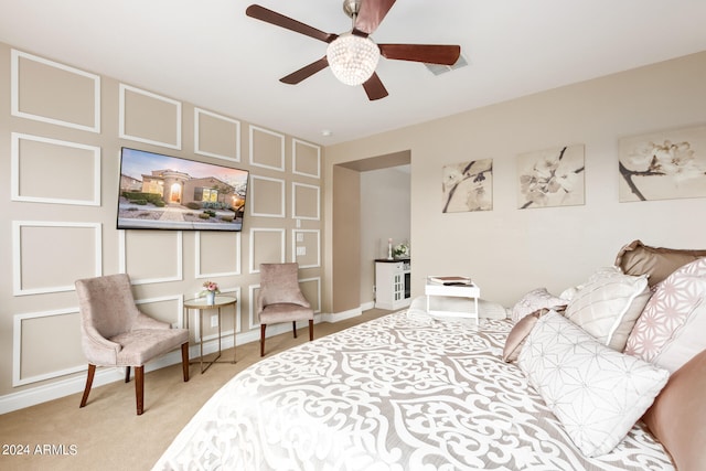 bedroom featuring light carpet and ceiling fan