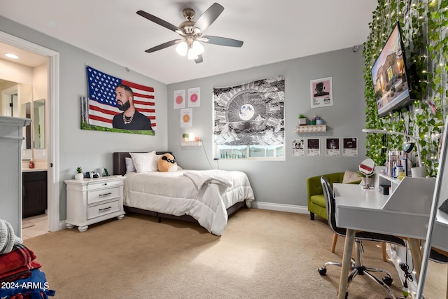 carpeted bedroom featuring ceiling fan and ensuite bath