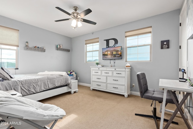 bedroom featuring ceiling fan and light carpet