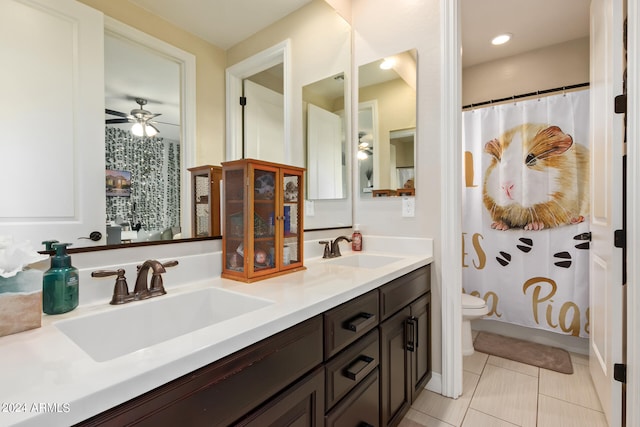 bathroom with double sink, ceiling fan, tile floors, toilet, and oversized vanity