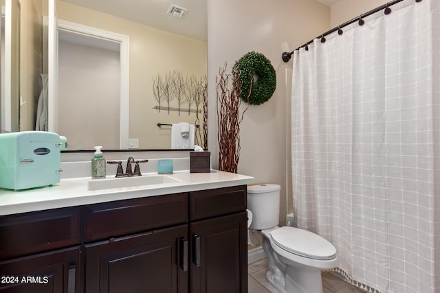 bathroom featuring tile floors, toilet, and oversized vanity