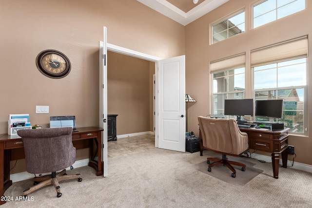 home office featuring light colored carpet and a high ceiling