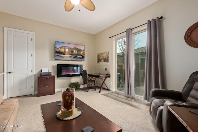 carpeted living room with ceiling fan