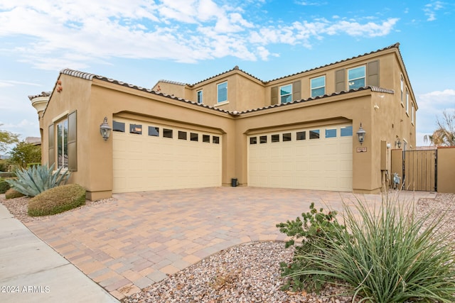 mediterranean / spanish home featuring a garage