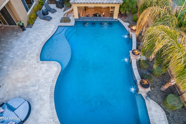 view of pool featuring pool water feature and a patio area