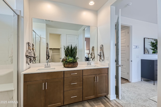 3129 S 155th Ln, Goodyear, AZ 85338 - full bath featuring a shower with shower door, wood finished floors, and double vanity