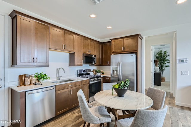 3129 S 155th Ln, Goodyear, AZ 85338 - kitchen with stainless steel appliances, light wood-style flooring, recessed lighting, and light countertops