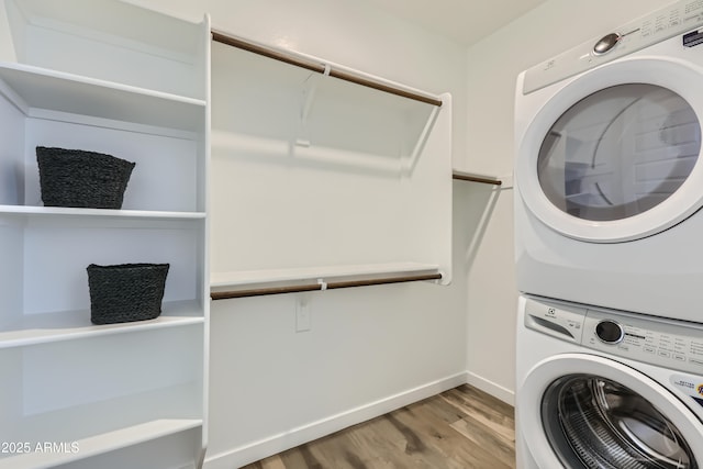 3129 S 155th Ln, Goodyear, AZ 85338 - laundry room featuring stacked washer / drying machine and wood finished floors