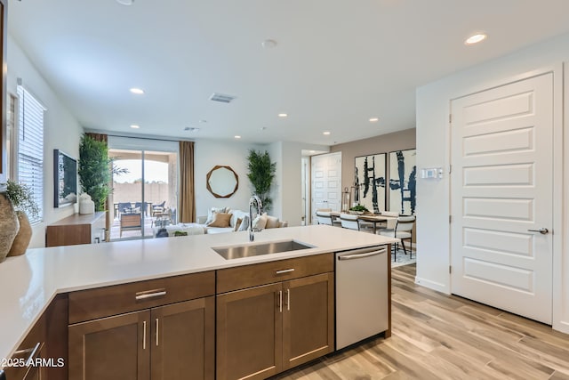 3129 S 155th Ln, Goodyear, AZ 85338 - kitchen featuring stainless steel dishwasher, light countertops, light wood-style floors, open floor plan, and recessed lighting
