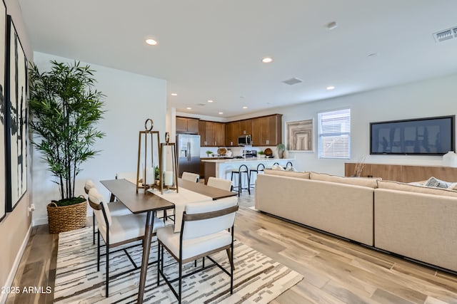 3129 S 155th Ln, Goodyear, AZ 85338 - dining space featuring light wood-type flooring and recessed lighting