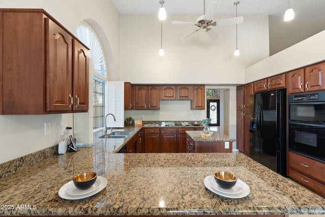 19275 N 88th Way, Scottsdale, AZ 85255 - kitchen featuring black appliances, dark stone counters, a high ceiling, a ceiling fan, and healthy amount of natural light