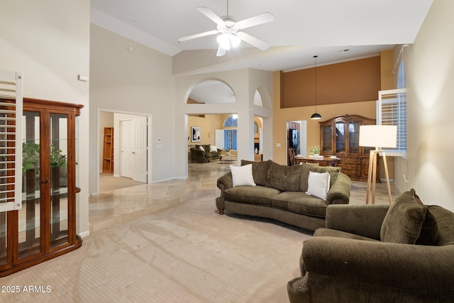 19275 N 88th Way, Scottsdale, AZ 85255 - living area featuring high vaulted ceiling, a ceiling fan, arched walkways, and light carpet