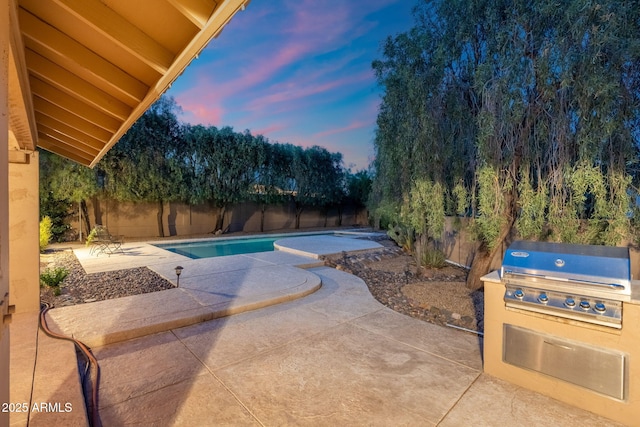 19275 N 88th Way, Scottsdale, AZ 85255 - pool at dusk featuring a patio area, a fenced backyard, and grilling area