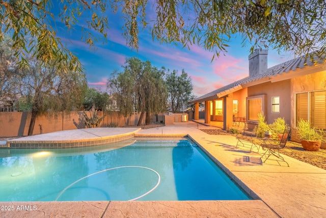 19275 N 88th Way, Scottsdale, AZ 85255 - pool at dusk with a patio area and a fenced backyard
