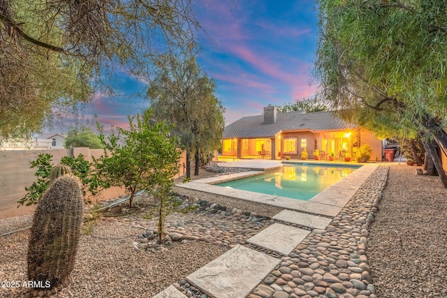 19275 N 88th Way, Scottsdale, AZ 85255 - pool at dusk featuring a patio area, an outdoor pool, and a fenced backyard