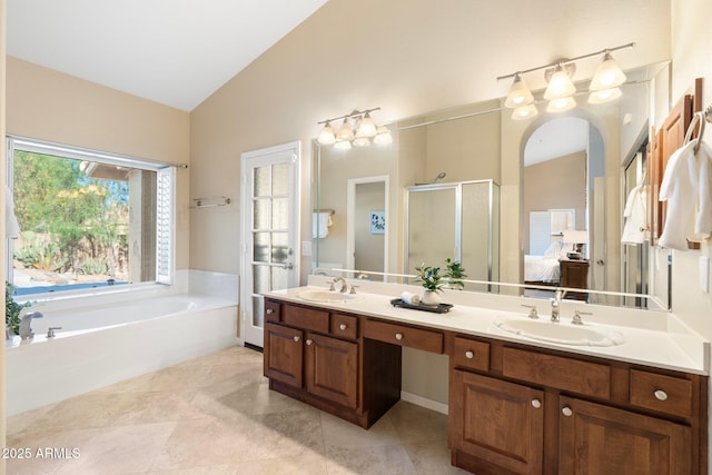 19275 N 88th Way, Scottsdale, AZ 85255 - bathroom featuring a stall shower, lofted ceiling, double vanity, a bath, and connected bathroom