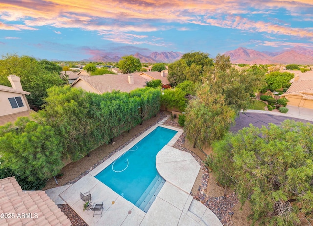 19275 N 88th Way, Scottsdale, AZ 85255 - pool at dusk featuring a mountain view, an outdoor pool, and a fenced backyard