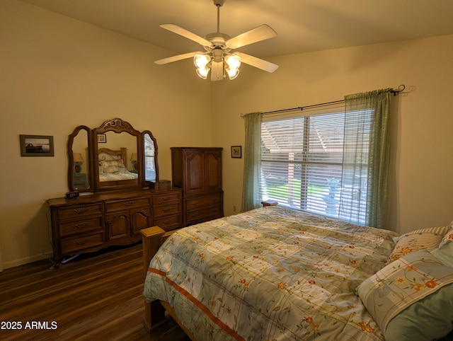 bedroom with a ceiling fan and dark wood-style floors