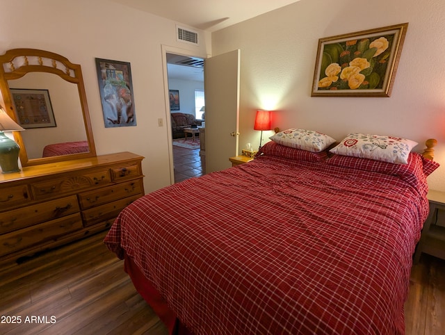 bedroom featuring visible vents and wood finished floors