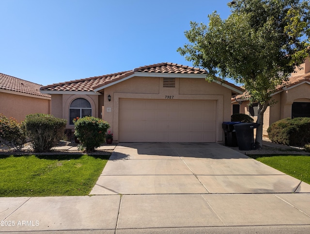 mediterranean / spanish house with a tile roof, an attached garage, driveway, and stucco siding