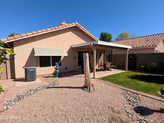 back of property featuring stucco siding, fence, a patio area, and a tiled roof