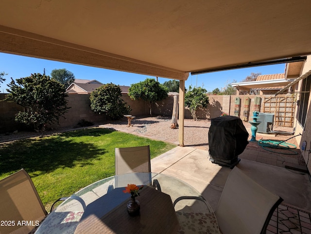 view of patio with outdoor dining space, a grill, and a fenced backyard