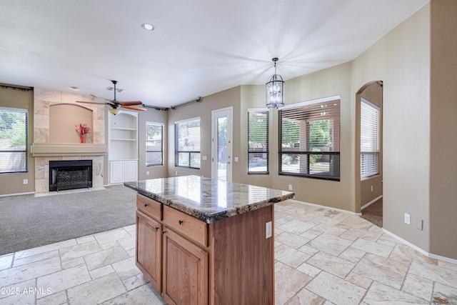 1470 W Bartlett Way, Chandler, AZ 85248 - kitchen with stone tile floors, ceiling fan, a fireplace, healthy amount of natural light, and recessed lighting