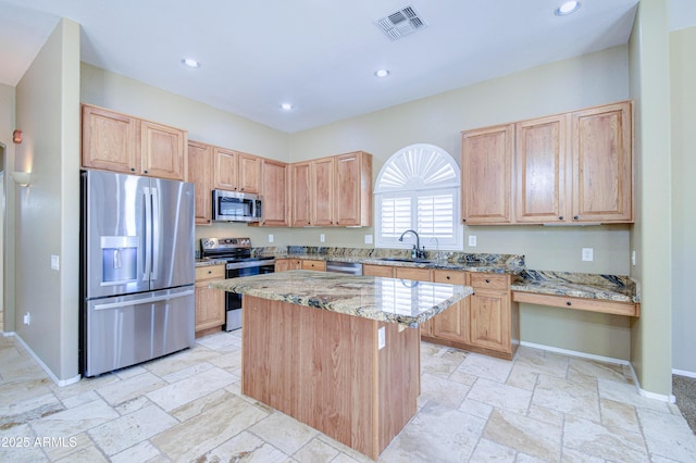 1470 W Bartlett Way, Chandler, AZ 85248 - kitchen with stainless steel appliances, a sink, light stone countertops, a kitchen island, and baseboards