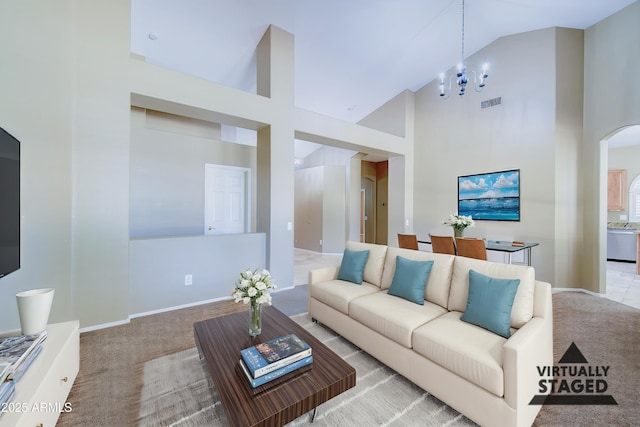 1470 W Bartlett Way, Chandler, AZ 85248 - living room with arched walkways, high vaulted ceiling, carpet floors, a chandelier, and baseboards