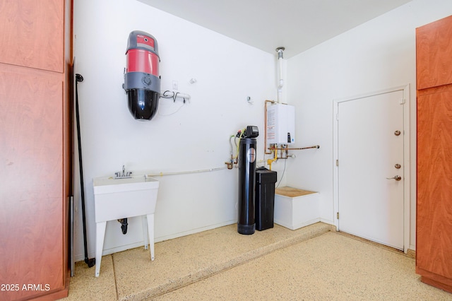 1470 W Bartlett Way, Chandler, AZ 85248 - interior space featuring tankless water heater, speckle patterned floor, and baseboards
