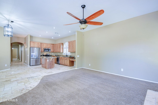 1470 W Bartlett Way, Chandler, AZ 85248 - kitchen featuring stainless steel appliances, open floor plan, baseboards, arched walkways, and a center island