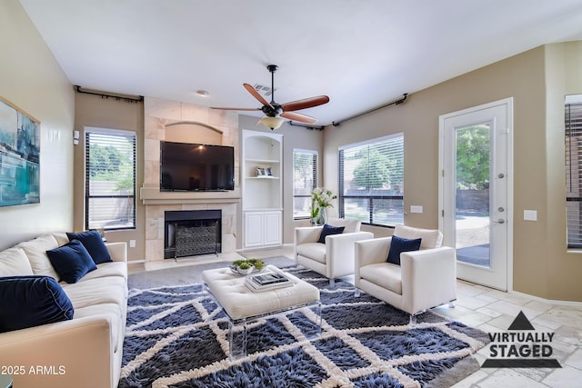 1470 W Bartlett Way, Chandler, AZ 85248 - living area featuring built in features, plenty of natural light, a ceiling fan, and a fireplace